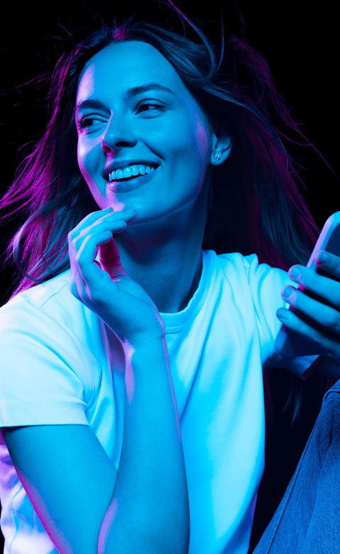 Happy girl holding phone and smiling 